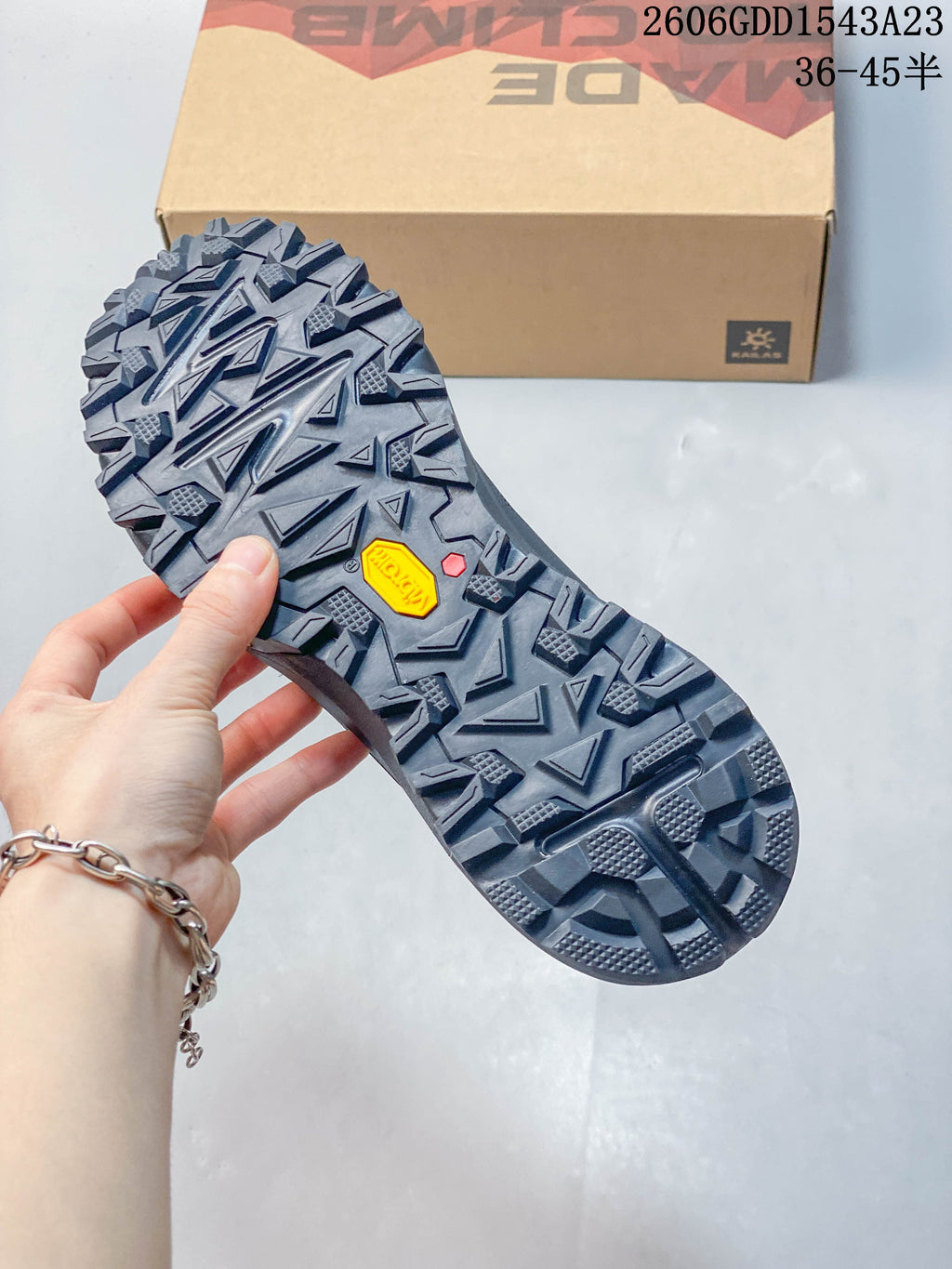 Close-up of the gray trail shoes' deeply lugged outsole