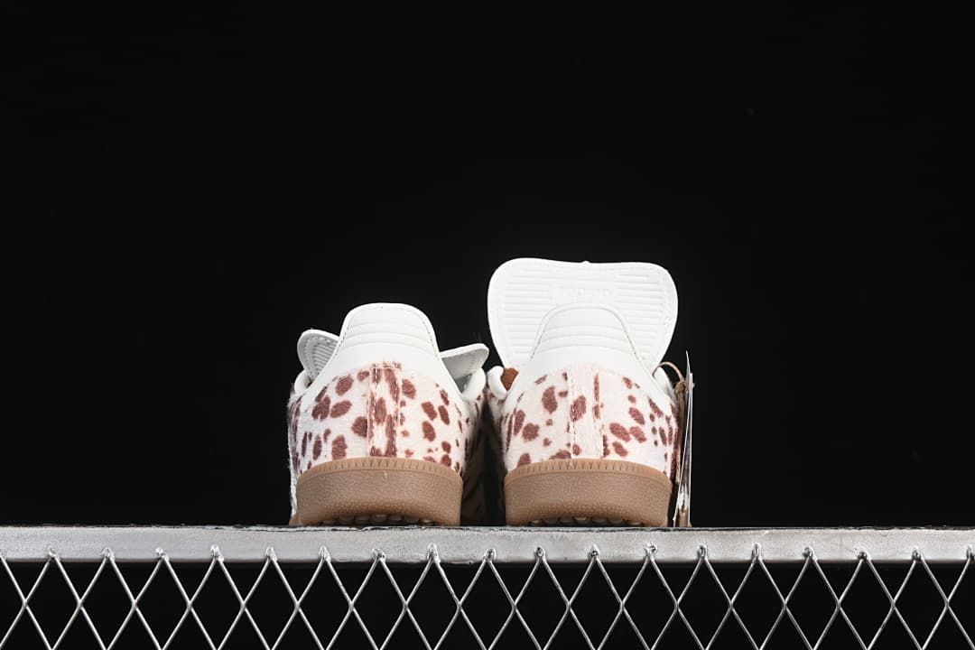 Rear view of both sneakers showing spotted heel panels and gum soles