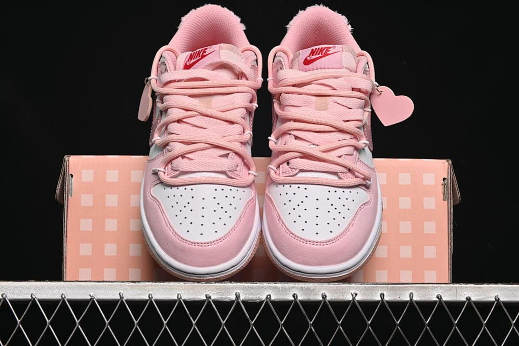 Front view of the pair with pink laces and perforated white toe panels.