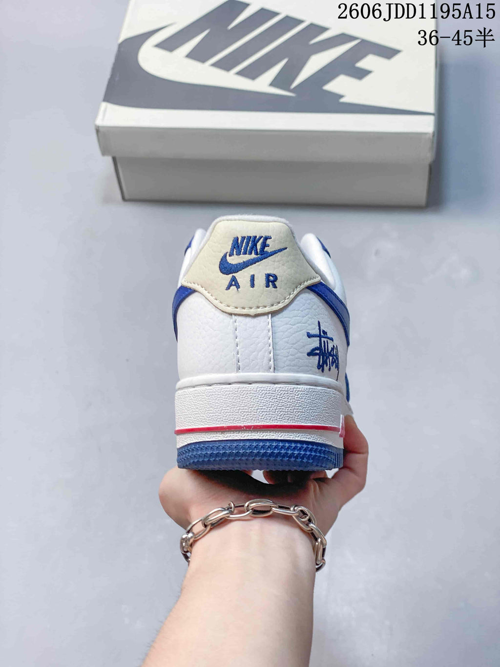 Rear view of a white and blue Nike Air Force 1 Low with heel graphics