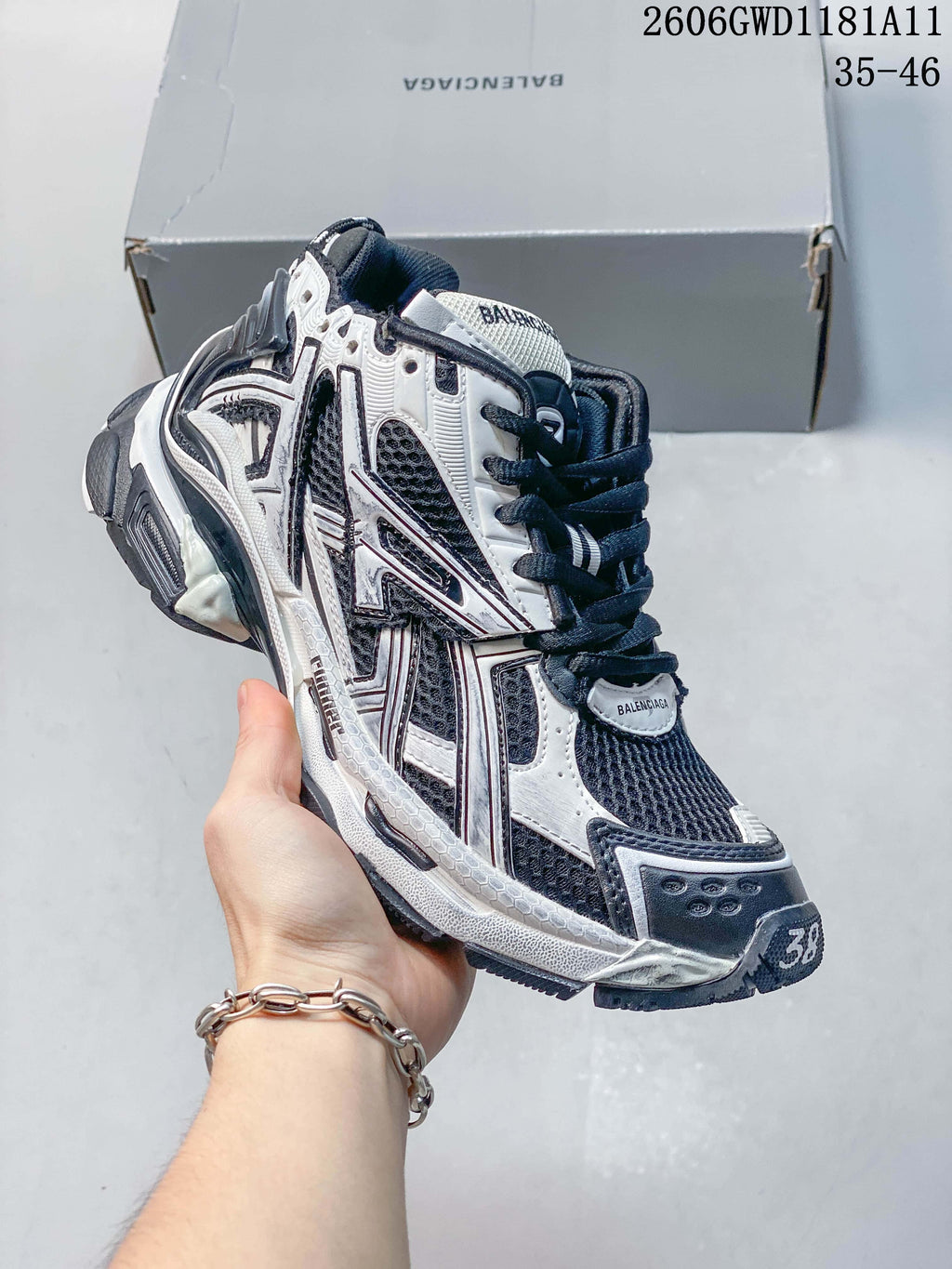 Angled side view of a Balenciaga Runner Gradient sneaker with layered panels and sculpted sole