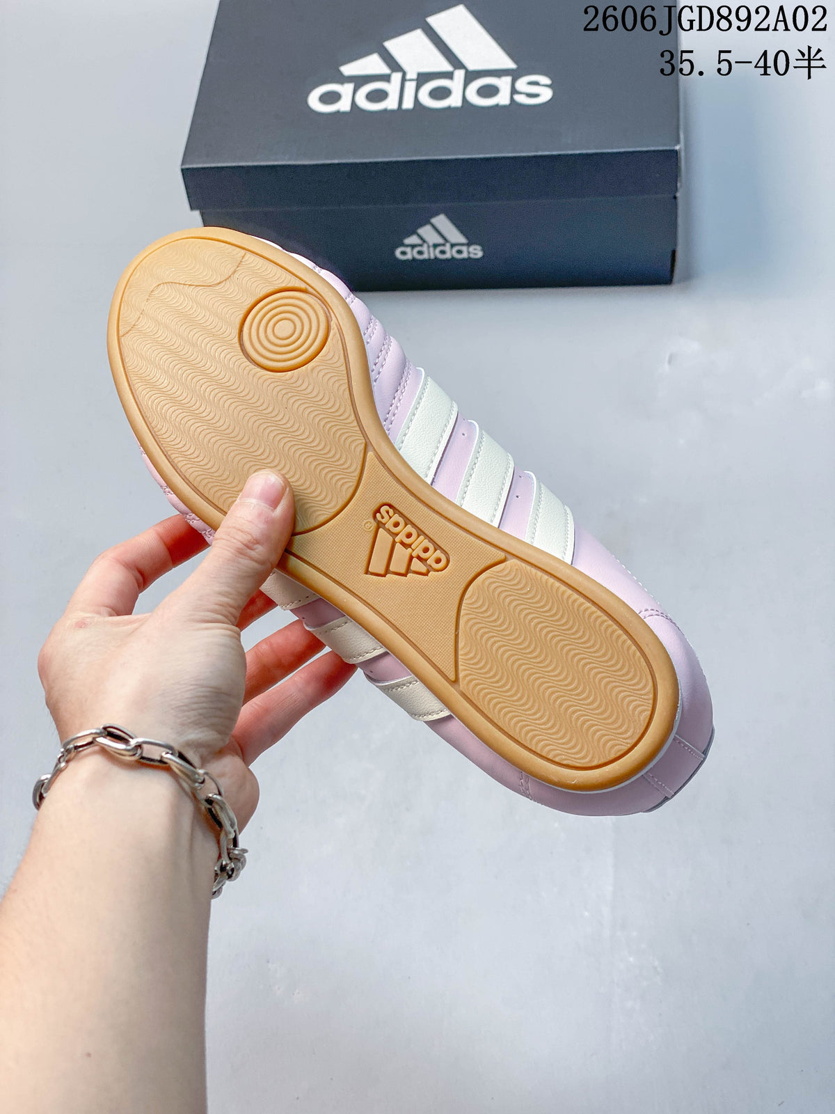 Underside of a pink Adidas Taekwondo shoe showing a gum-colored outsole