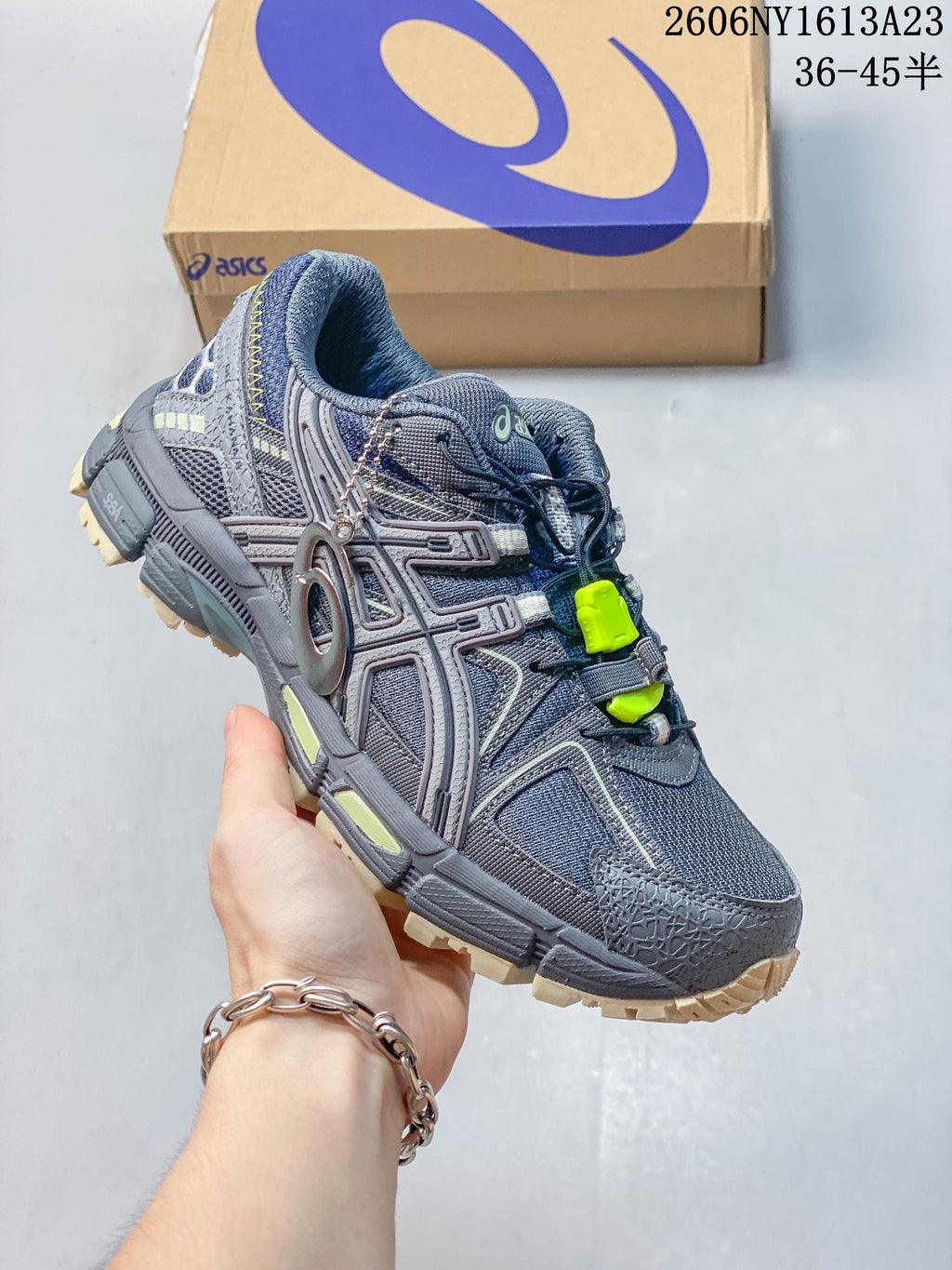 Angled view of a grey ASICS Gel-Kahana 8 FL sneaker with navy and lime accents