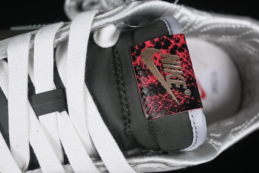 Close-up of the tongue label, white laces, and silver lining.