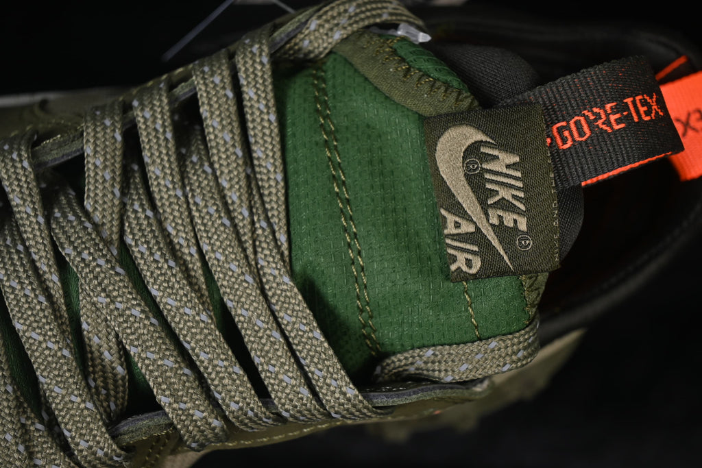 Close-up of the green tongue, lace pattern, and Gore-Tex lettering visible on a pull tab.