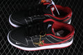 Black and red Nike SB Dunk Low sneakers with white contrast stitching and a gold horse-shaped lace charm