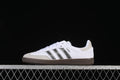 Side view of a white adidas Samba OG sneaker with metallic silver stripes and a dark brown sole