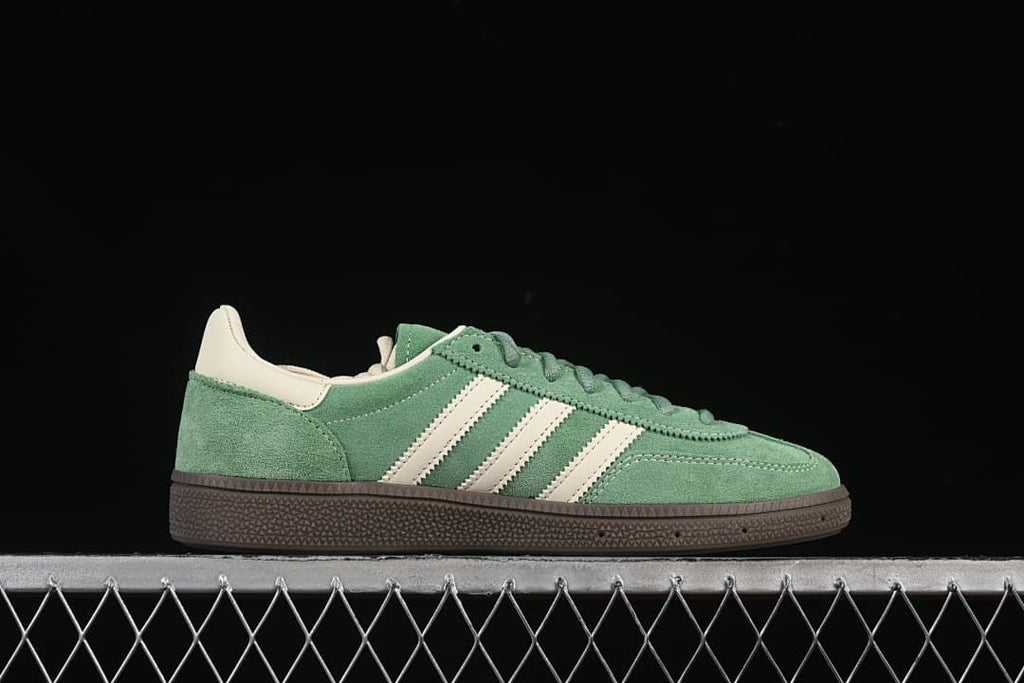 Side profile of a green Handball Spezial sneaker with cream stripes