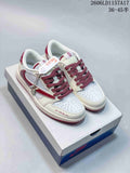 Pair of white and burgundy low-top sneakers shown from above on a shoebox