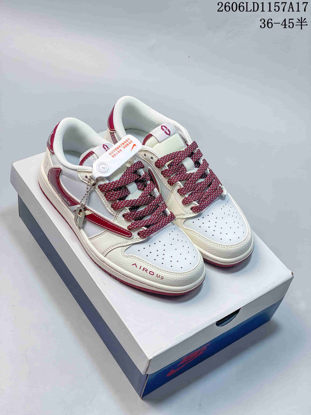 Pair of white and burgundy low-top sneakers shown from above on a shoebox