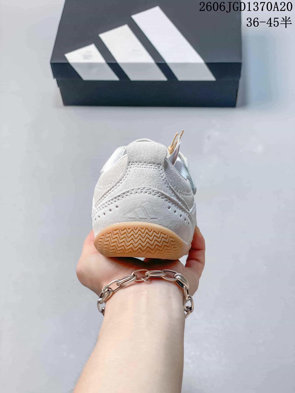 Rear view showing the shoe heel, adidas mark, and gum-colored outsole