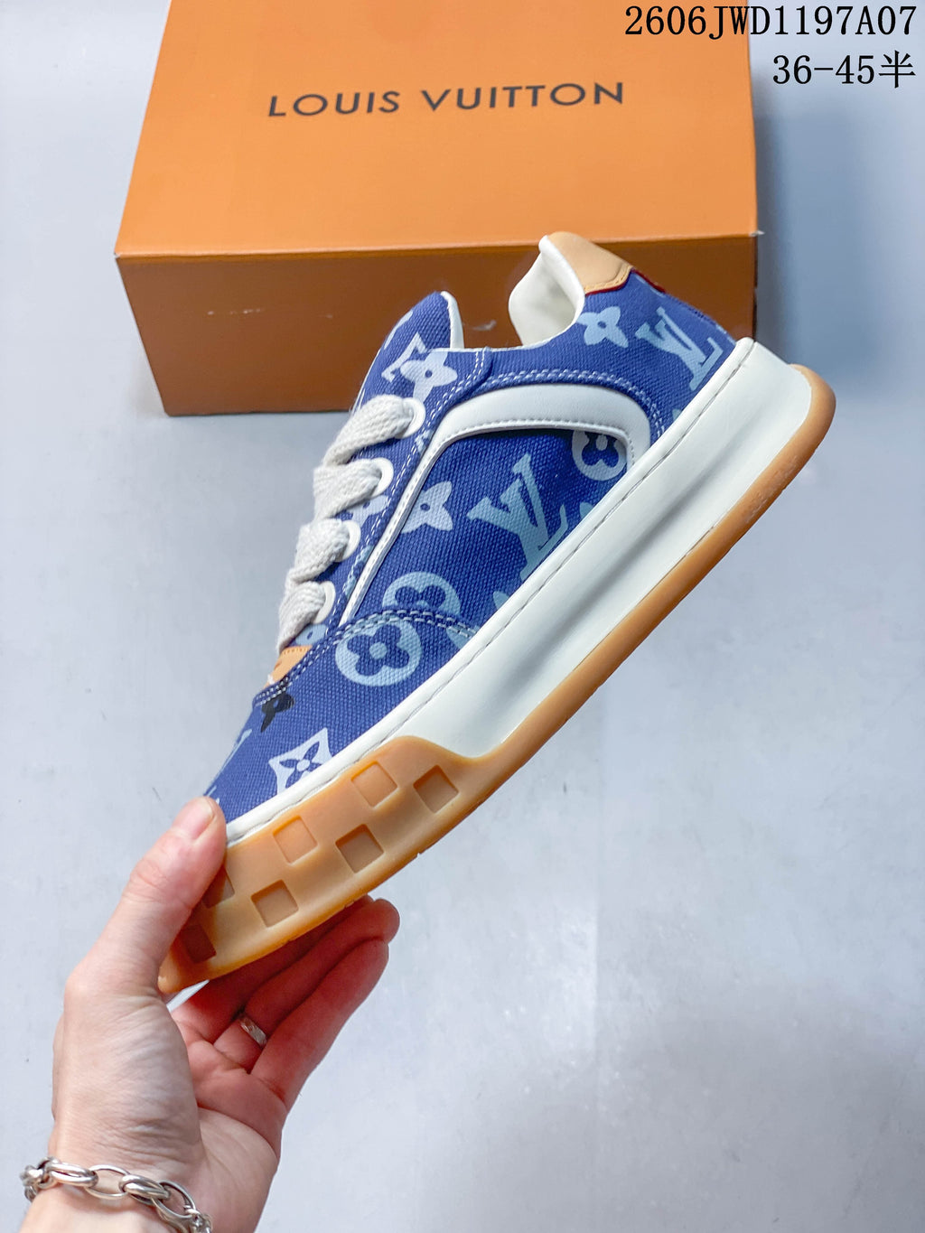Side profile showing the blue patterned upper, white trim, and chunky gum-colored sole