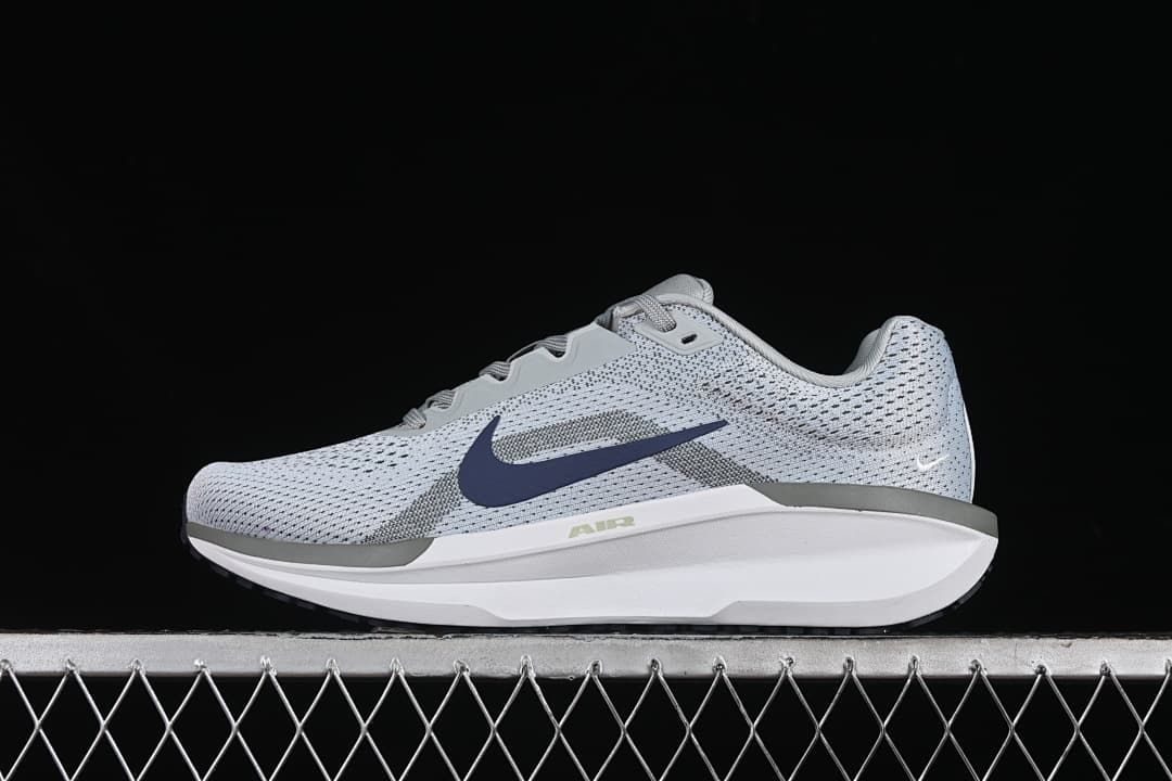Side view of a light gray Nike Zoom Winflo 11 shoe with navy Swoosh and white midsole