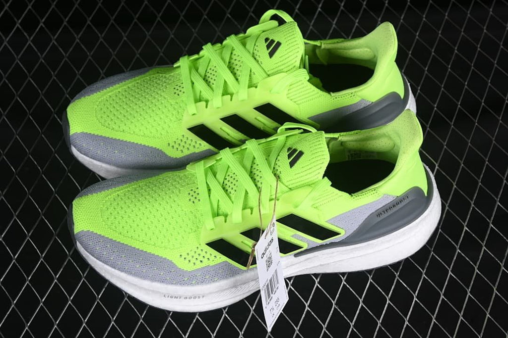 Pair of lime green and gray running shoes shown from the side
