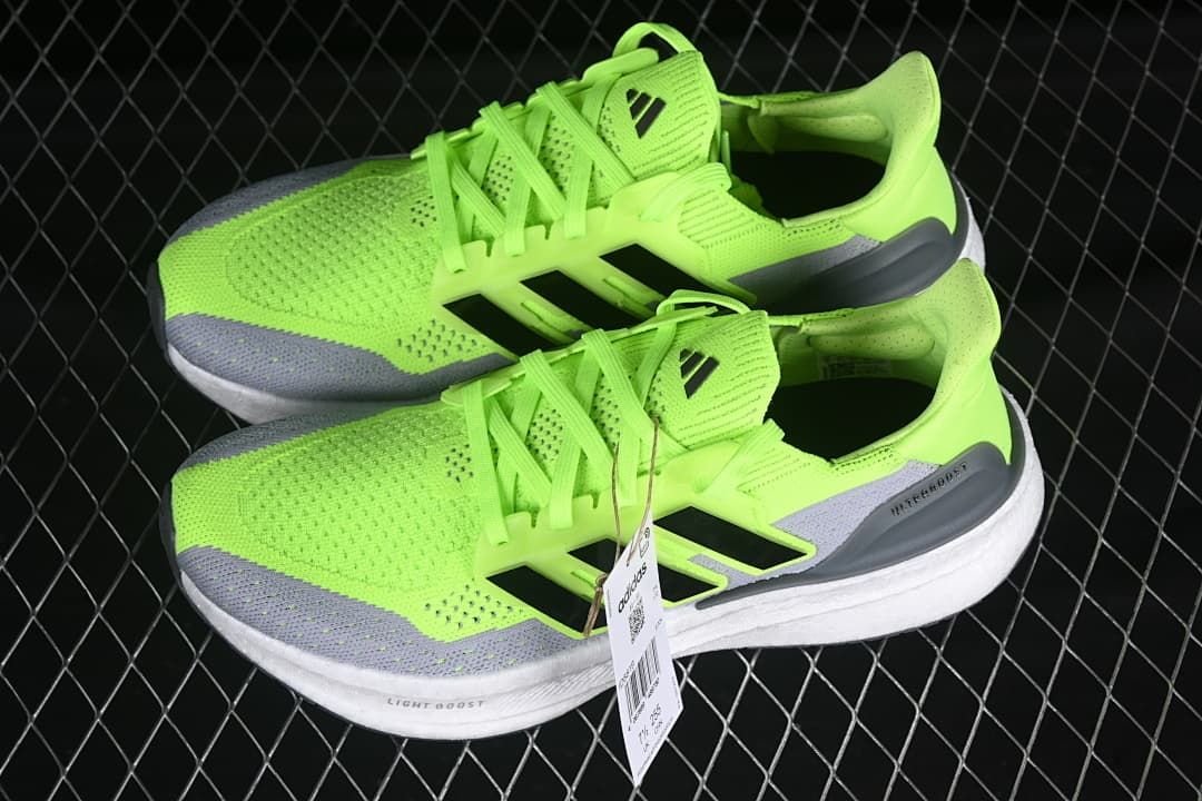 Pair of lime green and gray running shoes shown from the side