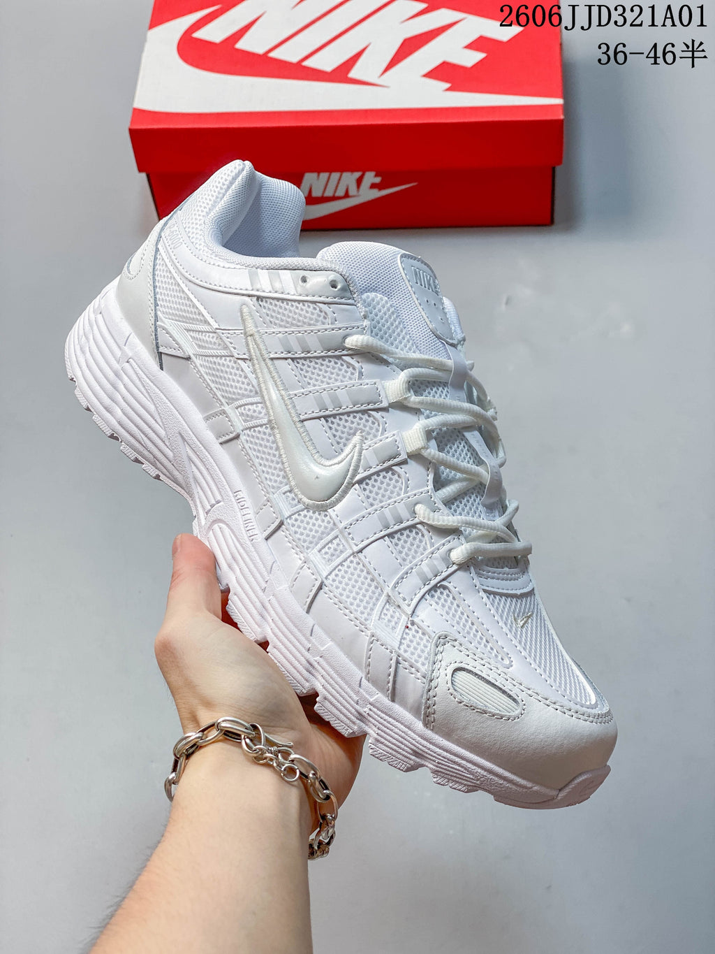 Side view of a white Nike P-6000 sneaker with layered panels and mesh details