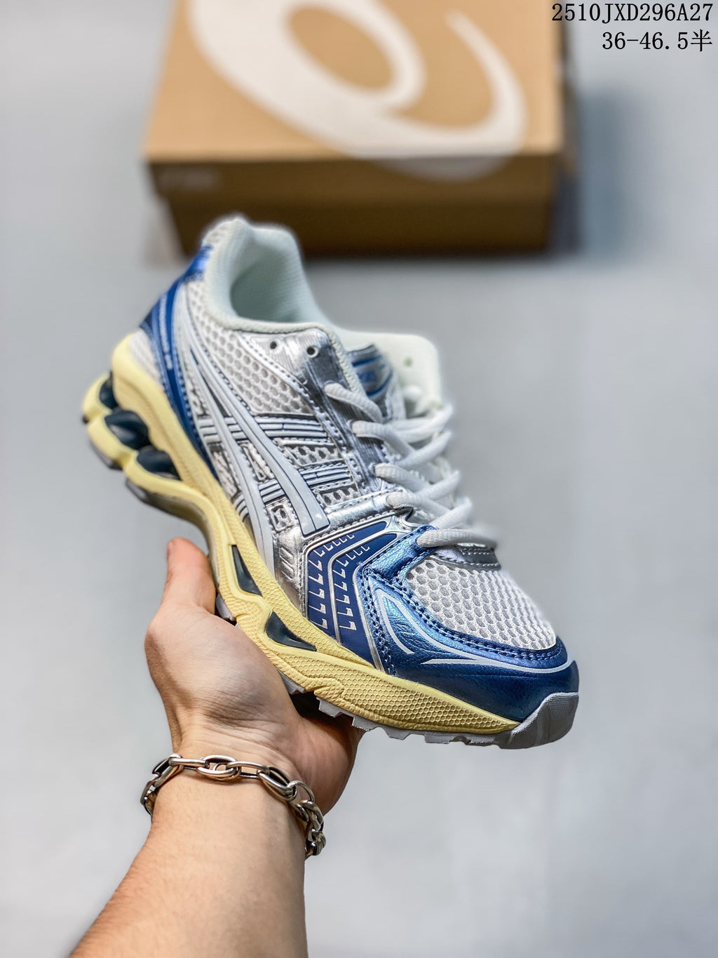 Silver and white mesh sneaker with blue accents and a pale yellow midsole, held in hand.