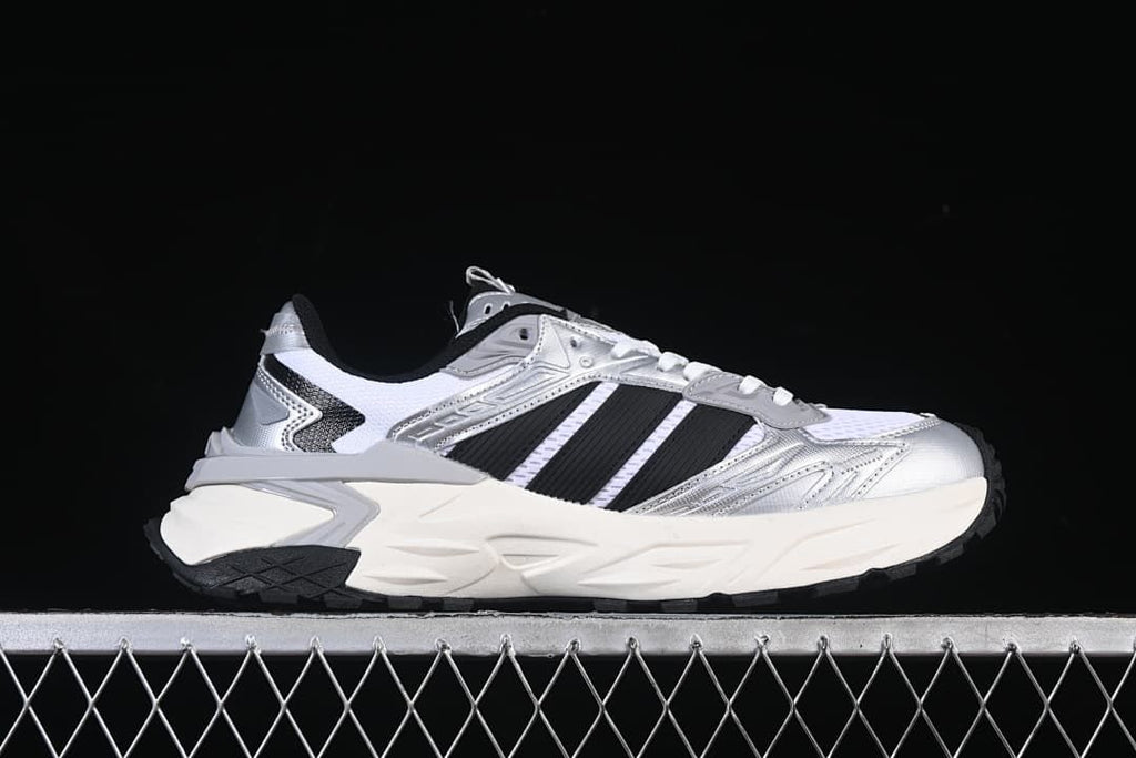 Side profile highlighting the silver panels and sculpted sole