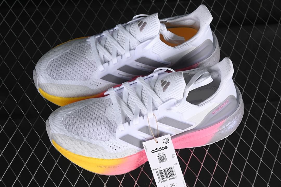 Pair of white Adidas Ultraboost 5 shoes shown from above and the side