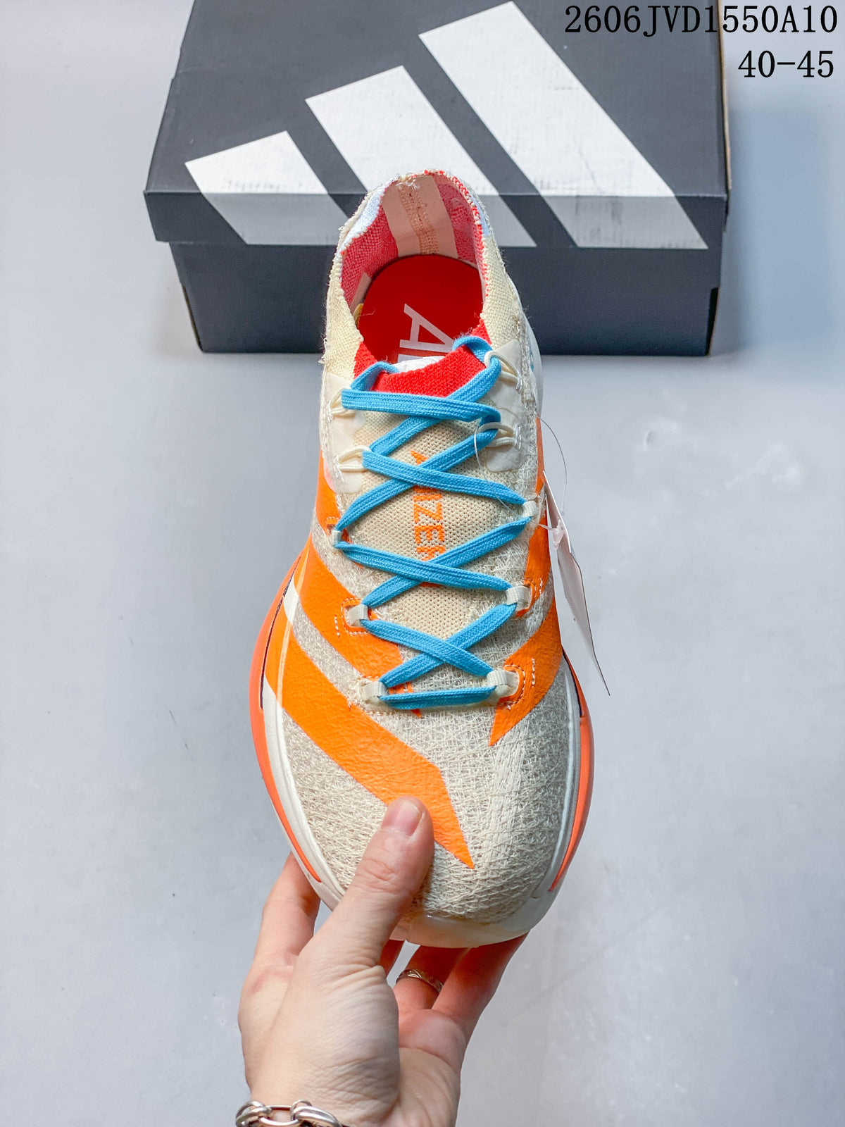 Top view of the running shoe showing its blue laces, cream upper and orange details.