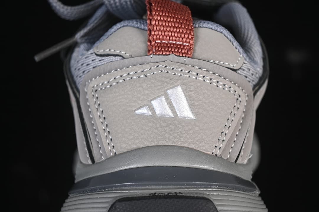 Rear view showing stitched heel panels, adidas logo, and red pull tab.