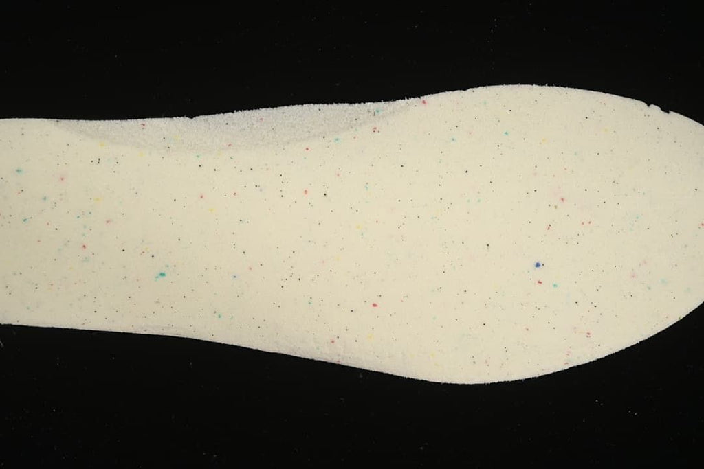 Light-colored shoe insert shown against a black background
