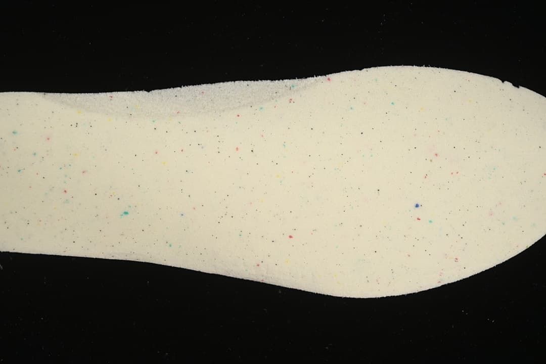 Light-colored shoe insert shown against a black background