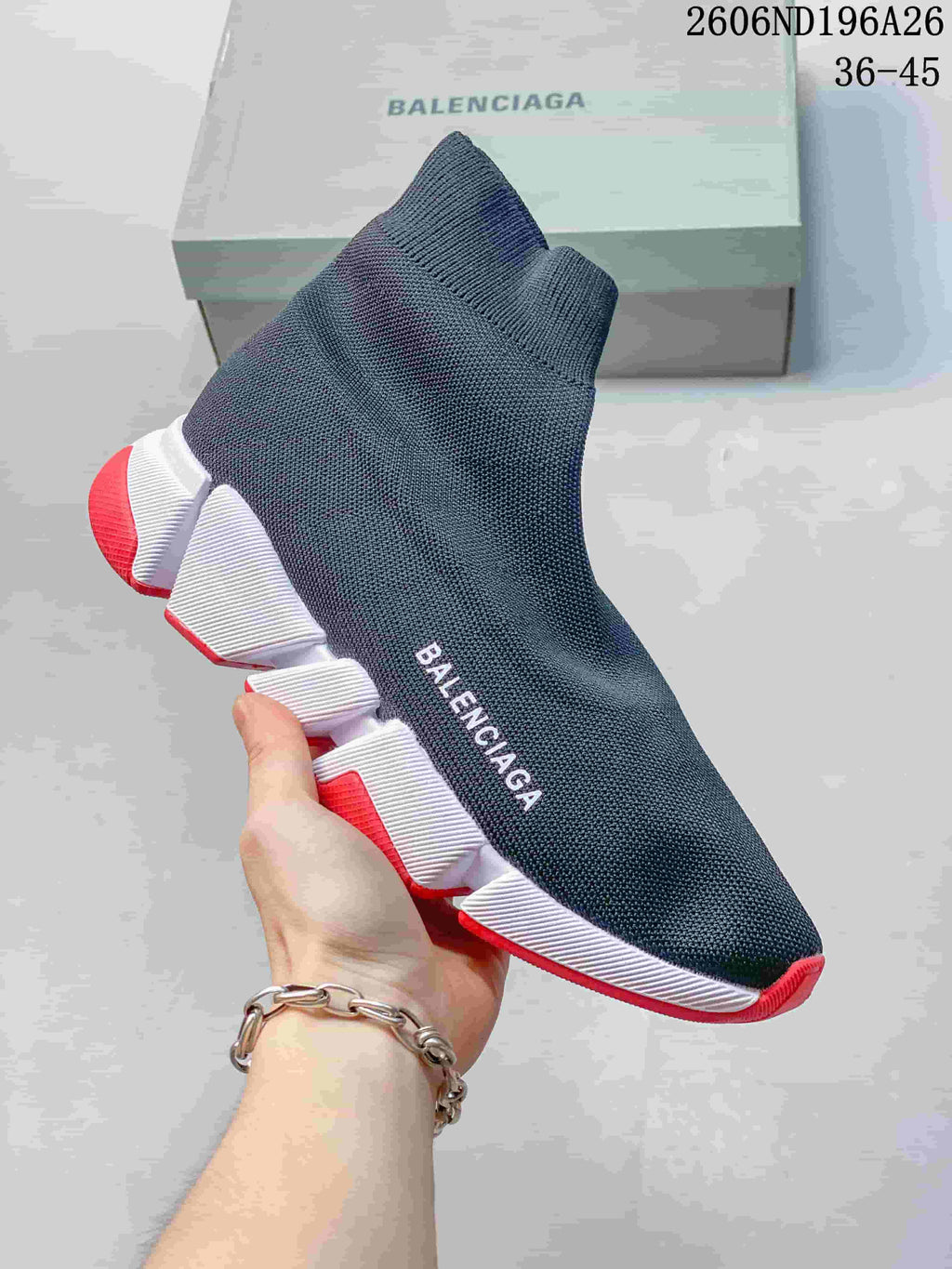 Dark blue knit sock sneaker with a white segmented sole and red accents