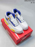 White Nike Flight Legacy mid-top sneakers with blue and yellow accents on a red Nike box