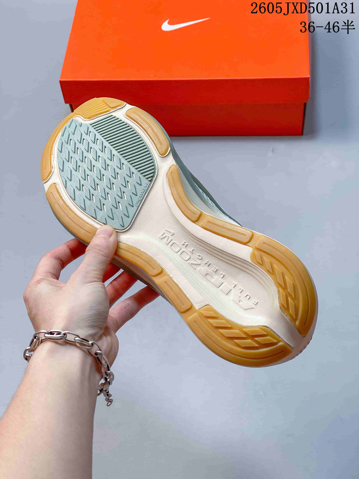 Underside of a running shoe showing a patterned grey outsole center and gum-colored rubber sections