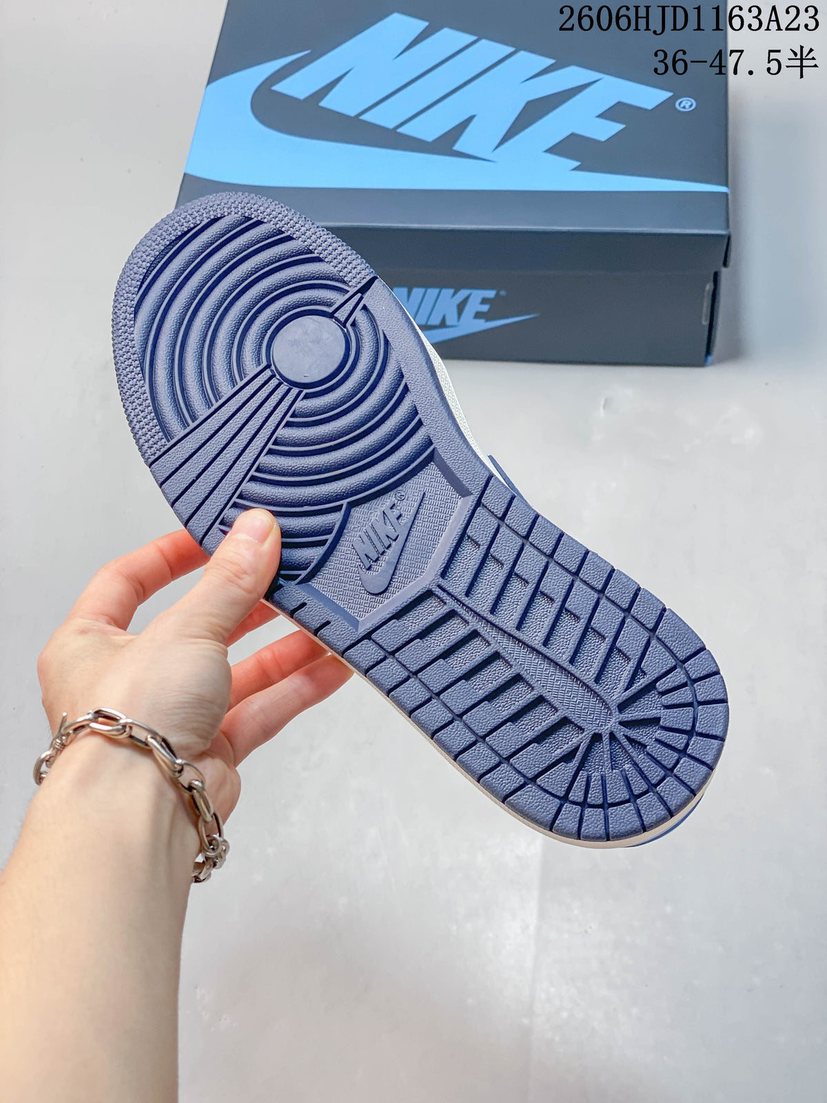 Close-up of the blue patterned outsole and shoe box