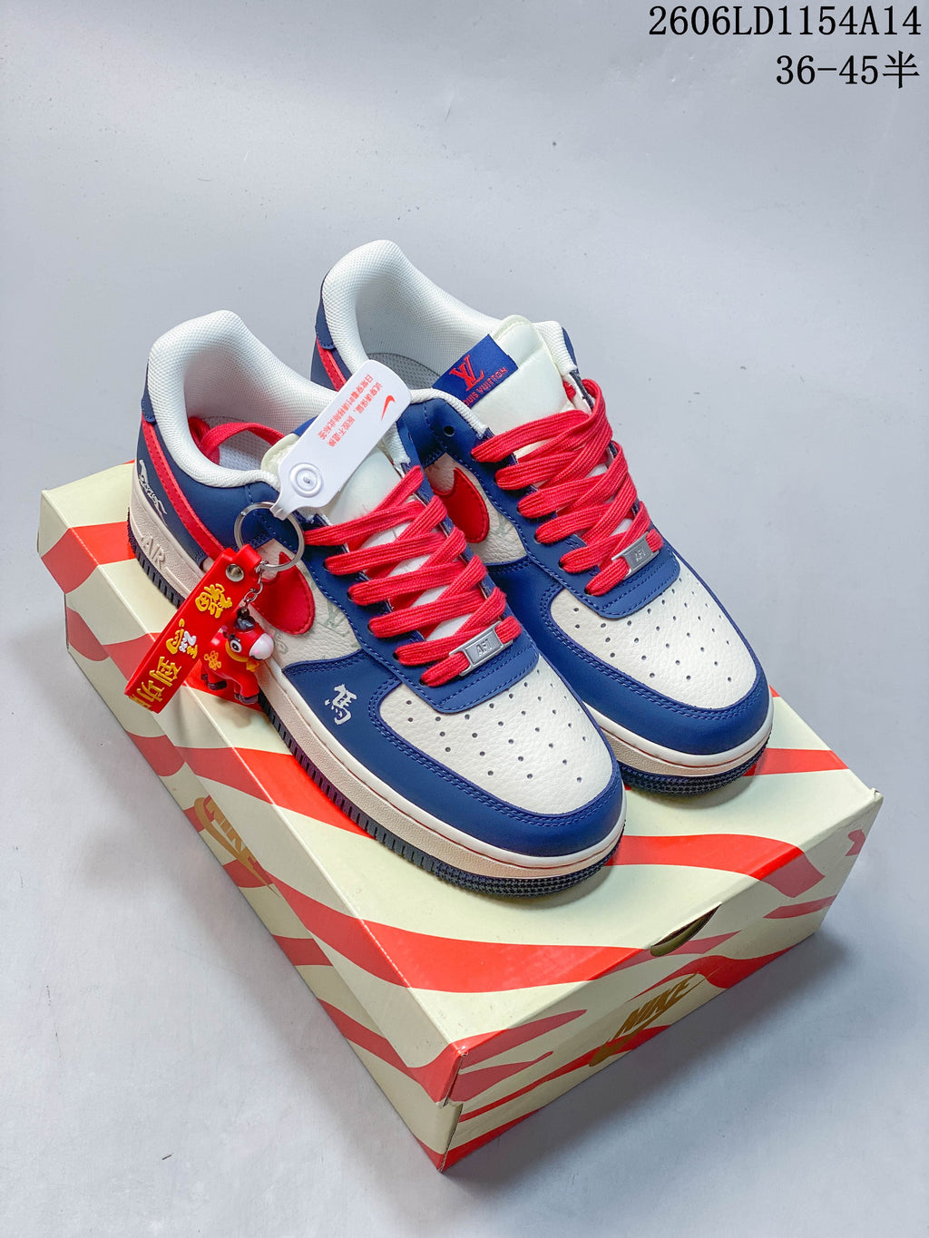 Pair of blue, white, and red low-top sneakers displayed on a patterned shoe box