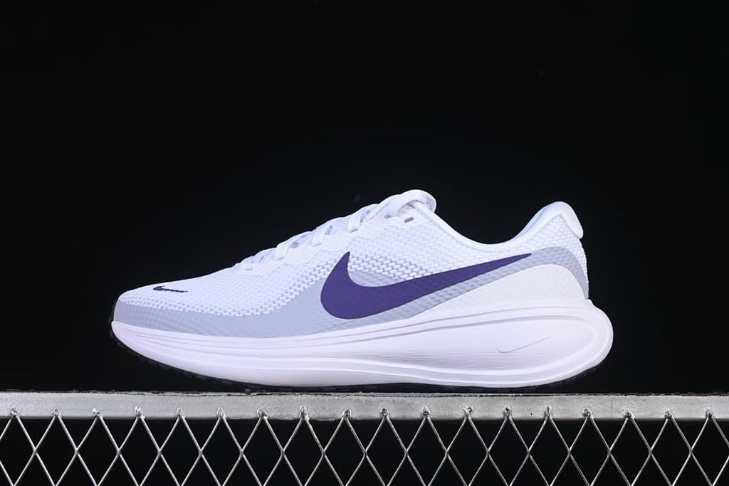 Side view of white Nike Revolution 8 running shoes with purple accents
