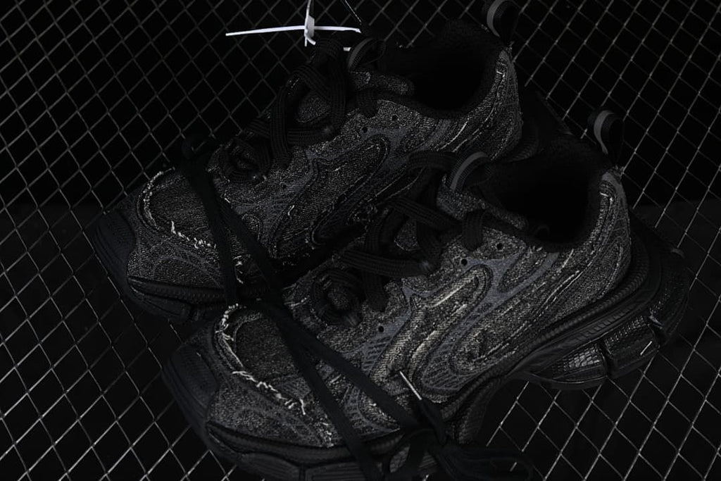 Pair of black textured sneakers shown together.