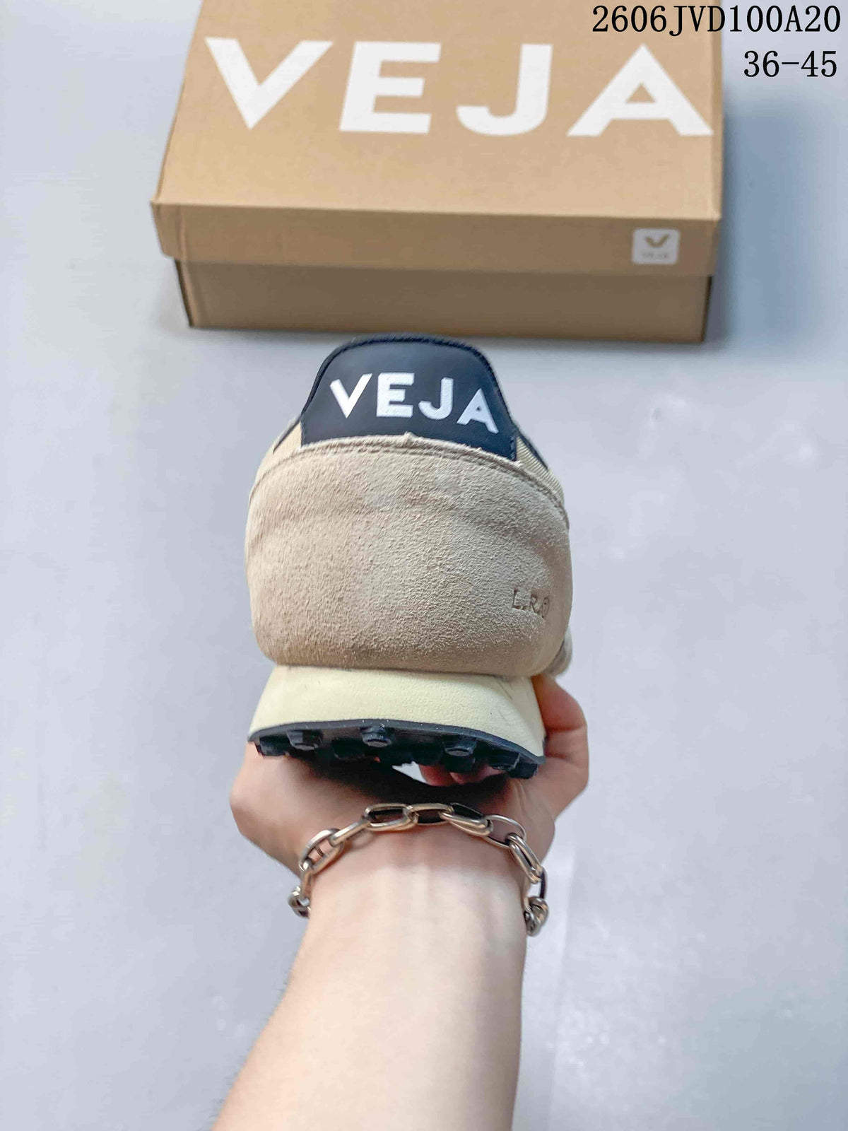 Rear view of a beige sneaker with a navy Veja heel tab