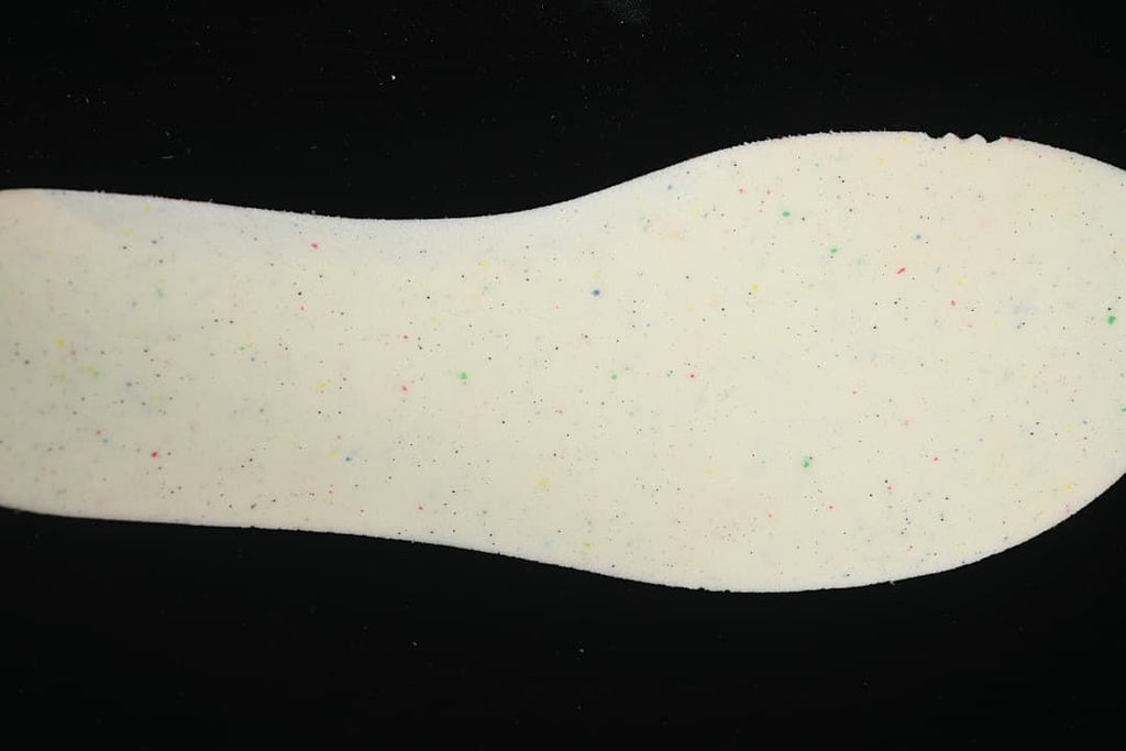 Close-up of the shoe's light-colored insole with multicolor speckles