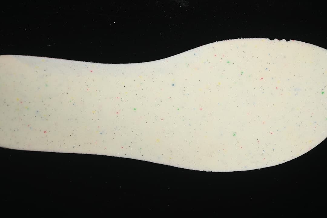 Close-up of the shoe's light-colored insole with multicolor speckles