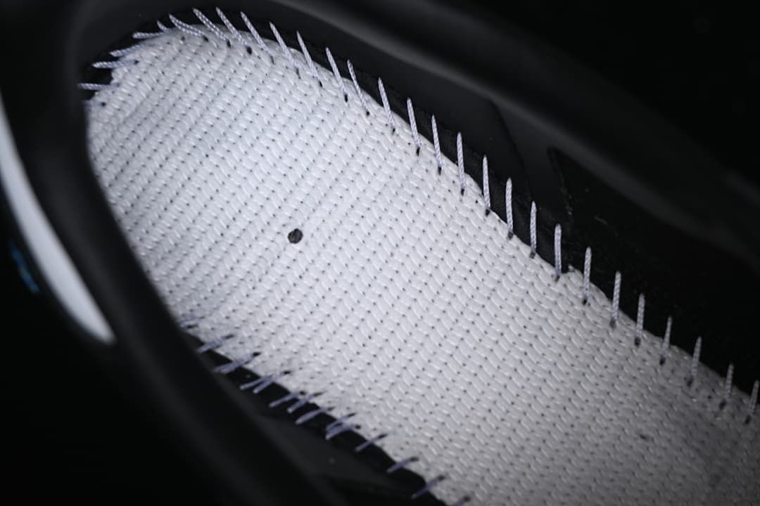 Close-up of a light-colored textured shoe interior panel