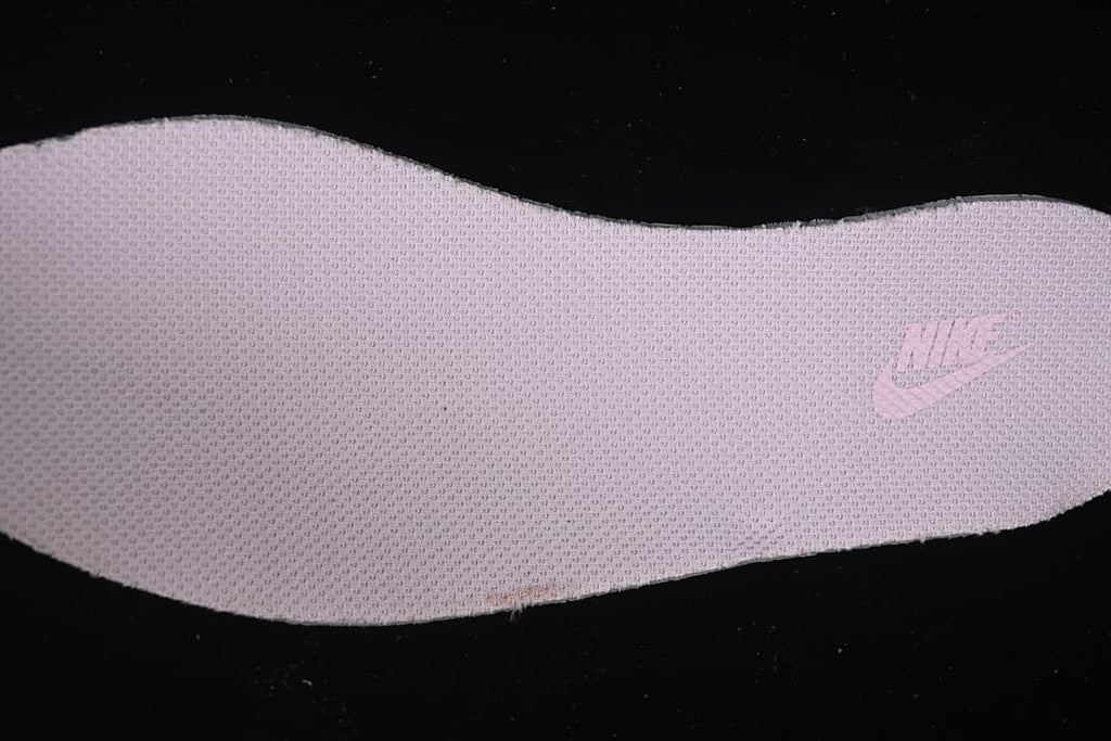 Close-up of a pink textured shoe component with a Nike logo
