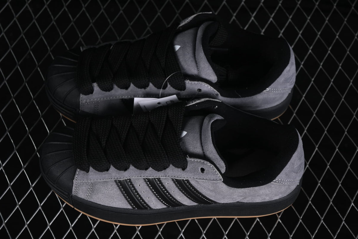 Top-down view of the pair showing black laces, shell toes, grey uppers, and black padded collars.