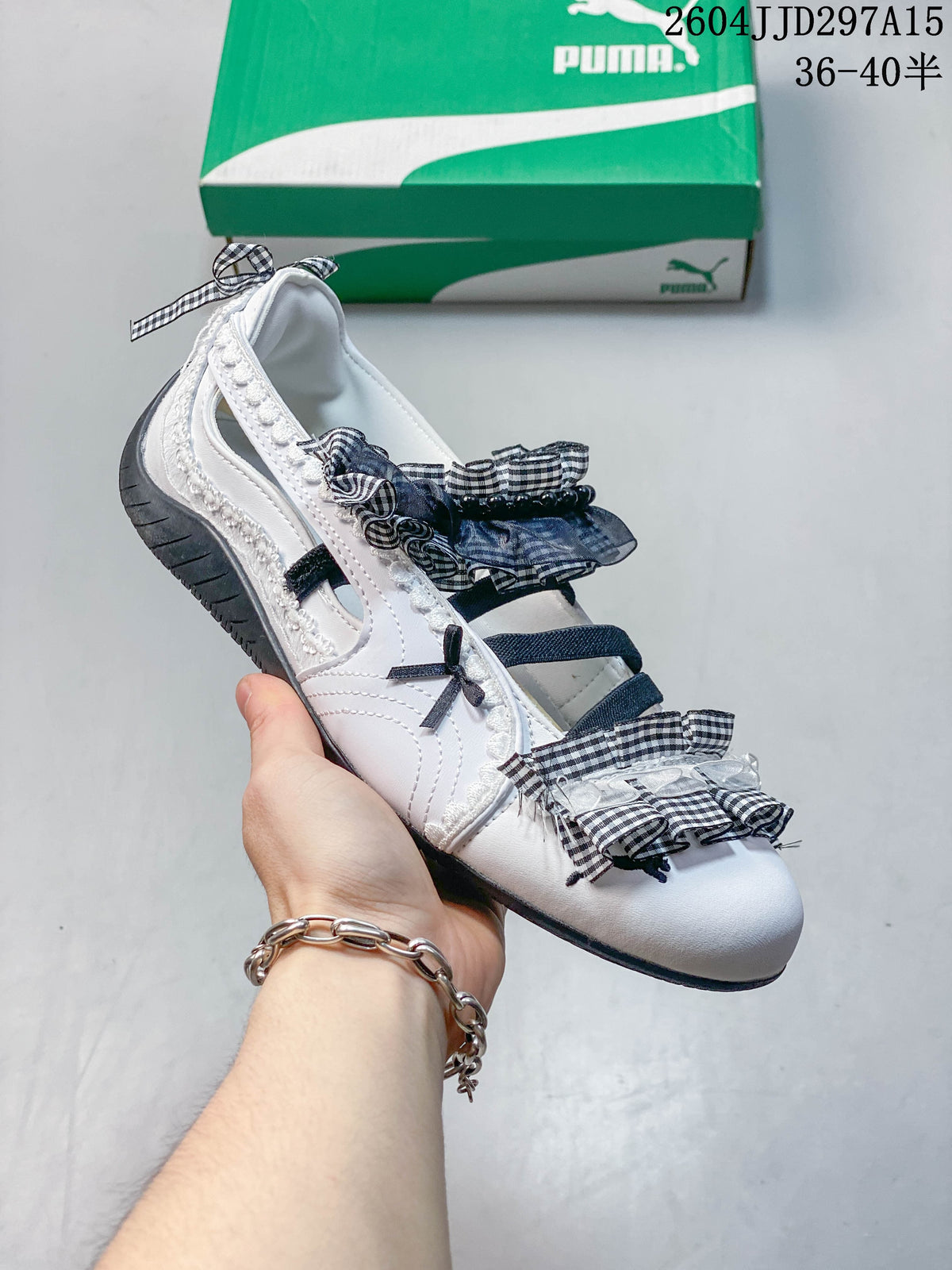 Angled view of a white flat with gingham ruffles, bows and dark straps.