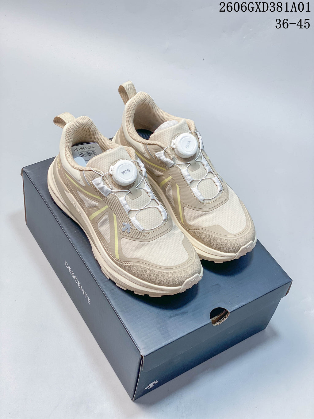 Pair of beige DESCENTE LAVITATE WIRE 3.0 sneakers with dial closures, shown on a shoe box