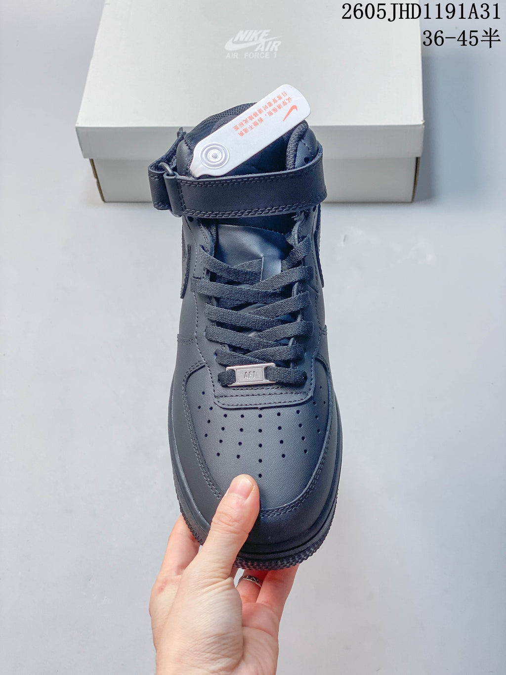 Front view showing the perforated toe, laces, and ankle strap of a gray high-top sneaker