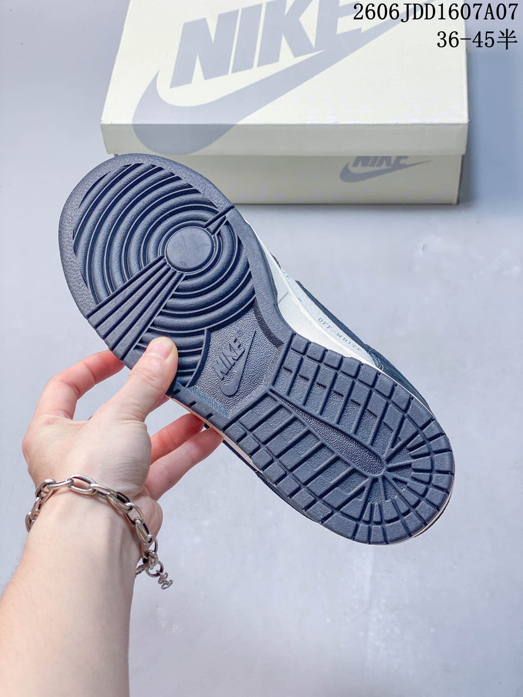 Underside of a Nike SB Dunk Low sneaker showing a dark blue patterned outsole