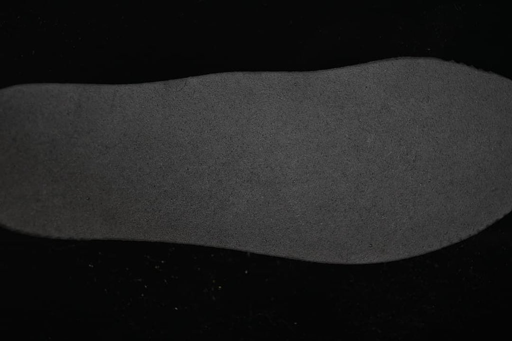 Close-up view of a dark textured sneaker outsole