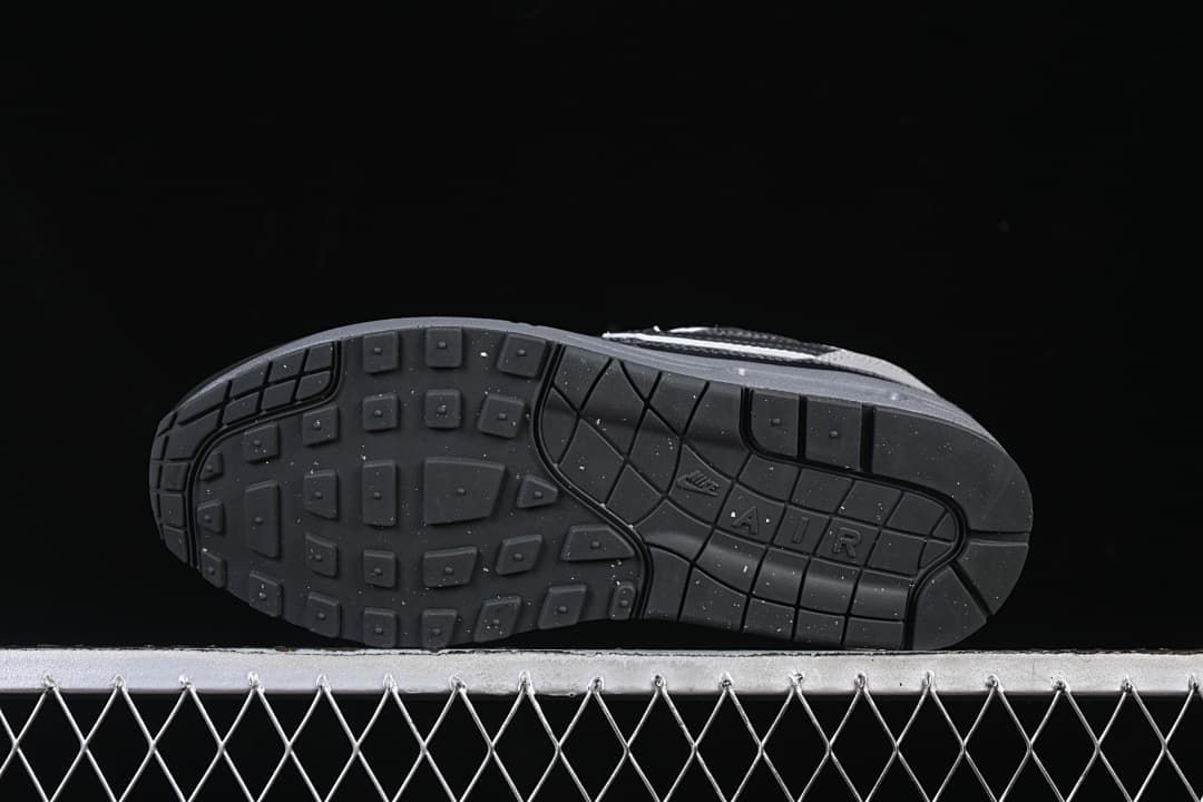Underside view showing the dark patterned rubber outsole