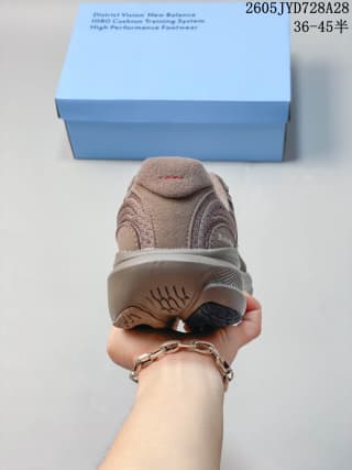 Rear view of a taupe-brown running shoe showing the heel and outsole