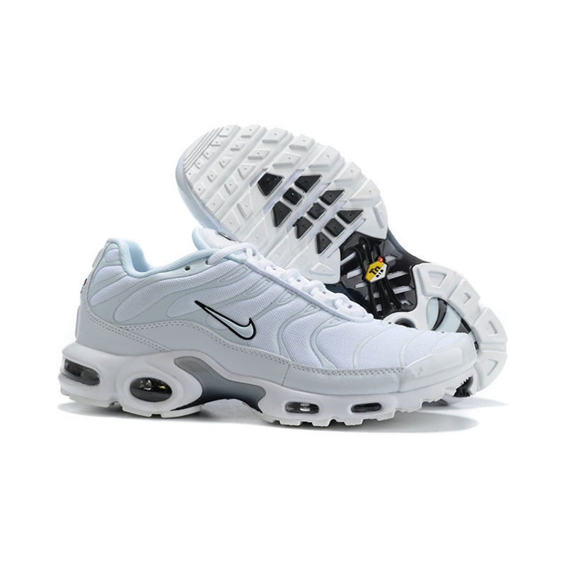 White Nike Air Max Plus-style sneakers with black accents and patterned outsole.