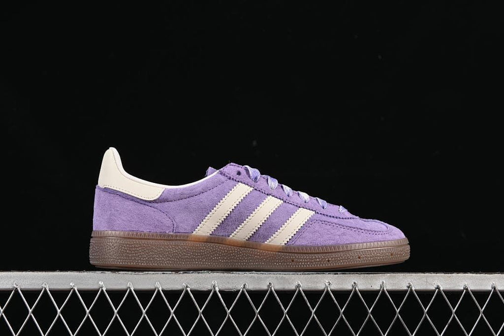 Side profile showing the purple upper, cream stripes, and brown sole