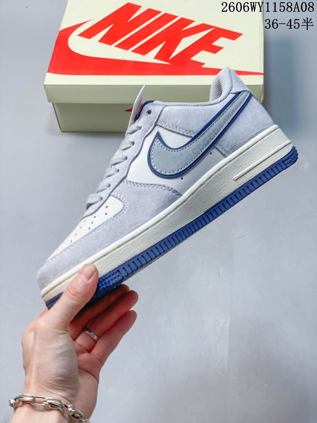 Side view of a gray and off-white Nike Air Force 1 '07 sneaker with blue Swoosh accents